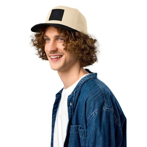 Man wearing black and beige five panel baseball cap with mid-profile fit on white background